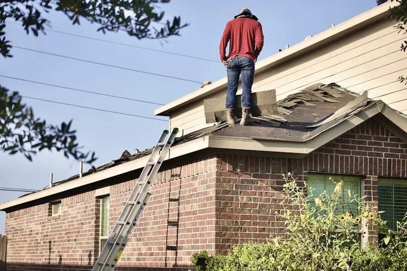 Professional roofer working on a residential roof in Random Woods